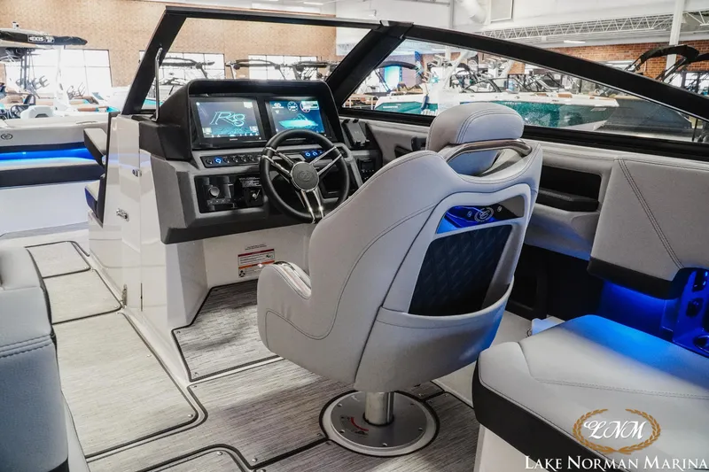 Slide: The Image of 2026 Cobalt R8 boat interior with modern dashboard and steering, showcased at Lake Norman Marina. - 15