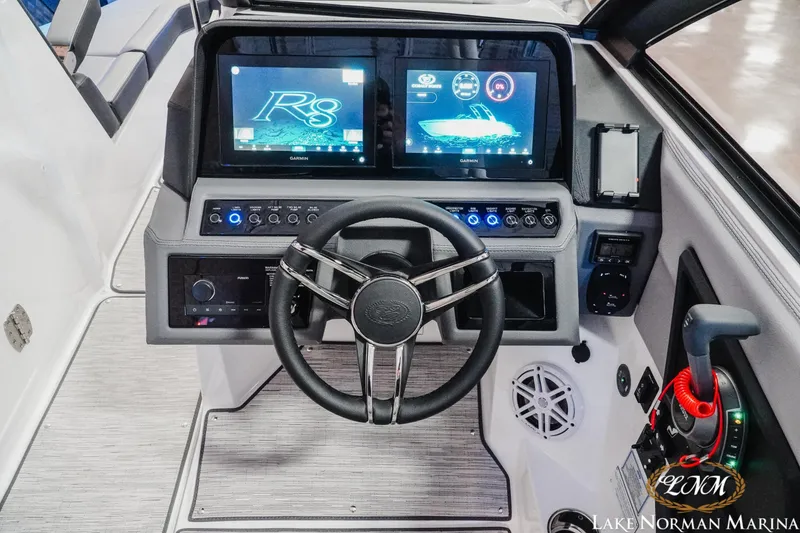 Slide: The Image of 2026 Cobalt R8 boat dashboard with dual Garmin displays and modern controls. - 18