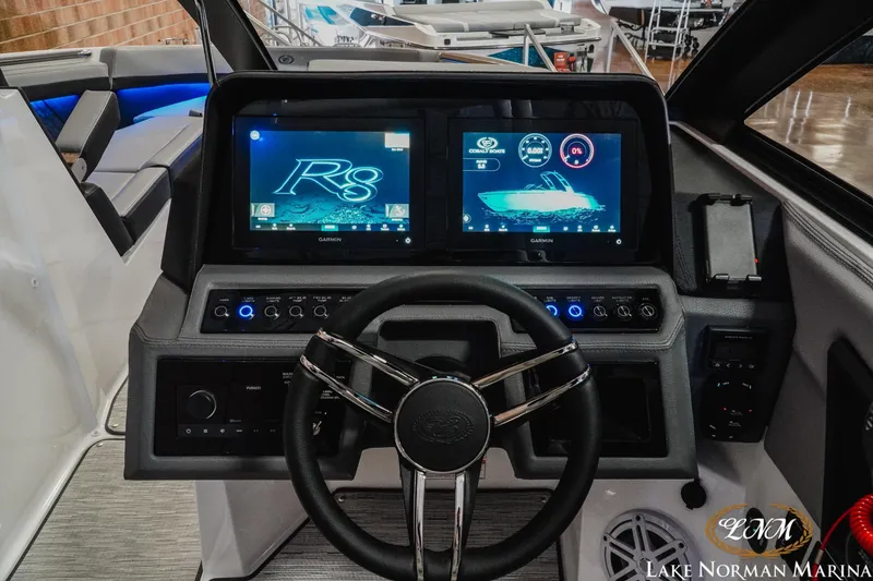 Slide: The Image of 2026 Cobalt R8 boat dashboard with dual Garmin displays and modern steering wheel. - 19