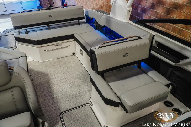 Slide: The Image of 2026 Cobalt R8 boat interior with gray seating and blue LED lighting at Lake Norman Marina. - 25