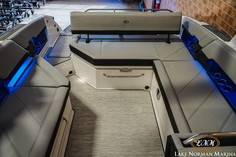 Slide: The Image of 2026 Cobalt R8 boat interior with gray seating, blue LED lighting, and cup holders. - 27