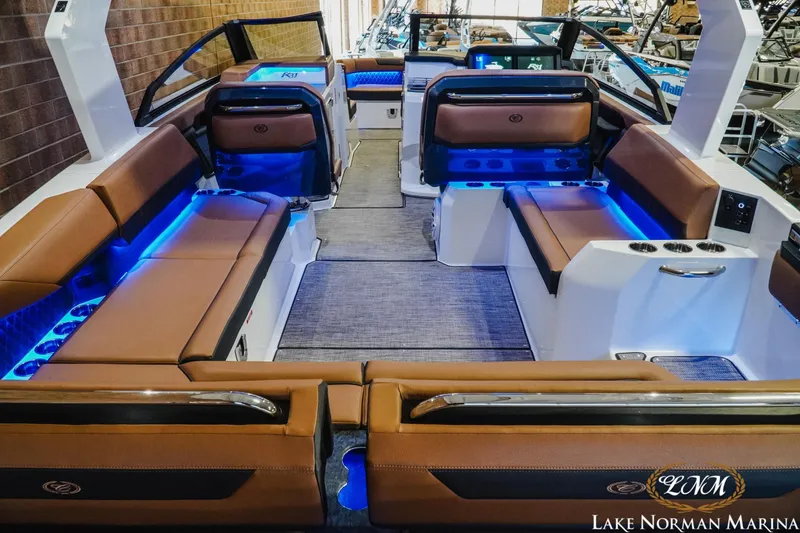 Slide: The Image of Luxurious 2026 Cobalt R31 boat interior with brown seating and blue LED lighting. - 12