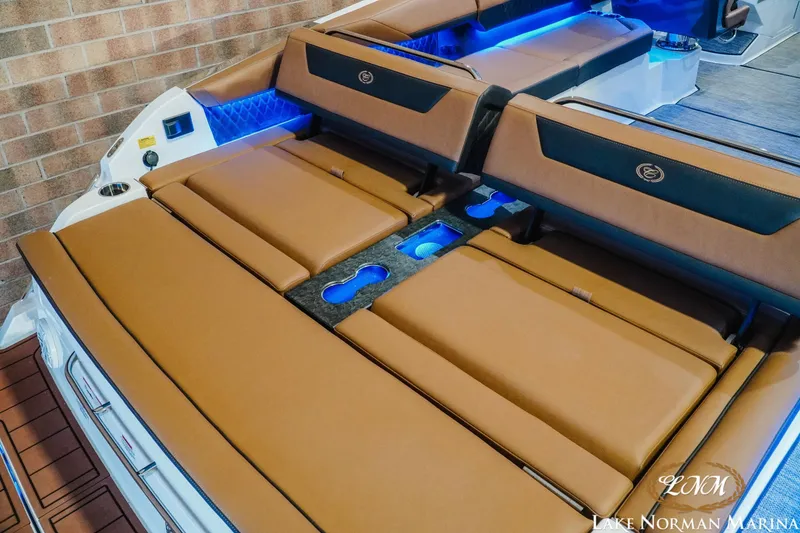 Slide: The Image of 2026 Cobalt R31 boat interior with tan seating and blue LED lighting. - 13