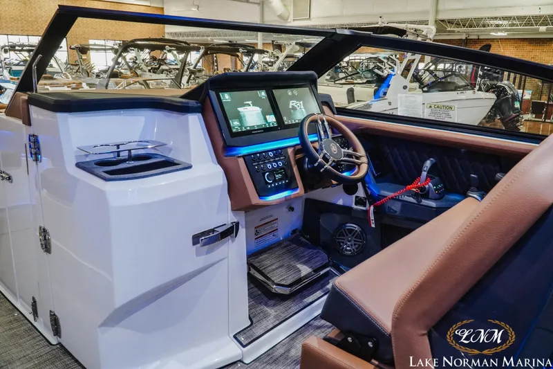 Slide: The Image of Interior of 2026 Cobalt R31 boat with modern dashboard and steering wheel at Lake Norman Marina. - 19