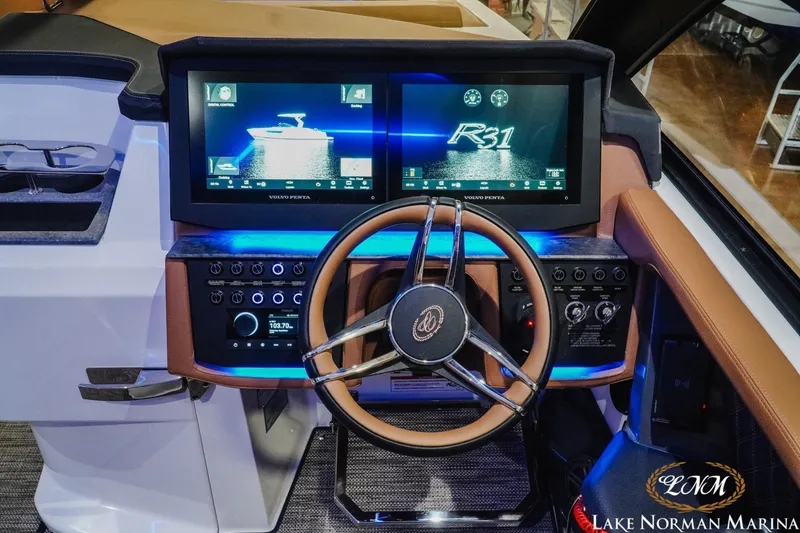 Slide: The Image of 2026 Cobalt R31 boat dashboard with dual screens and modern steering wheel at Lake Norman Marina. - 20