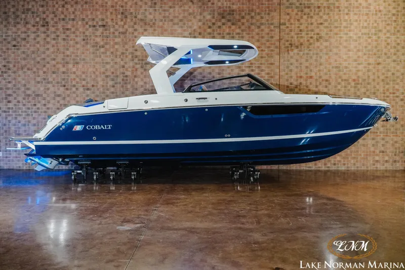 Slide: The Image of 2026 Cobalt R31 boat in showroom, blue and white design, Lake Norman Marina. - 29