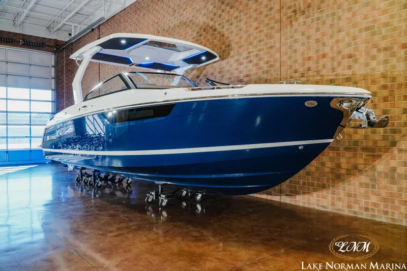 Slide: The Image of 2026 Cobalt R31 boat in showroom, blue hull, modern design, Lake Norman Marina. - 3