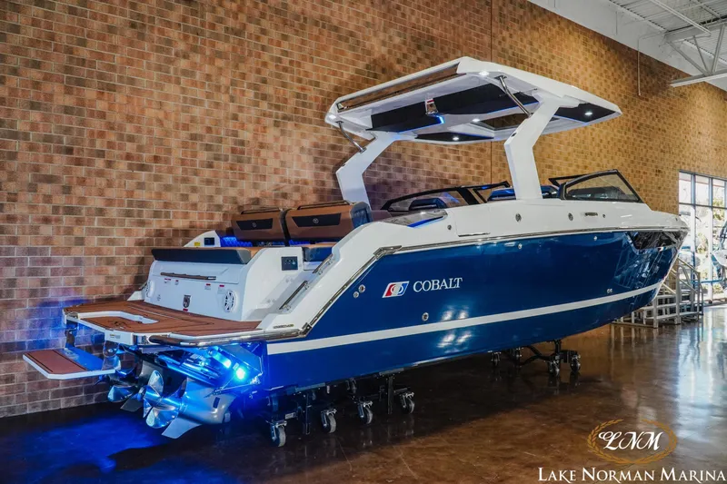 Slide: The Image of 2026 Cobalt R31 boat with blue hull and modern design at Lake Norman Marina. - 30