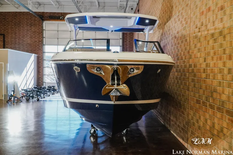 Slide: The Image of 2026 Cobalt R31 boat displayed indoors at Lake Norman Marina. - 32