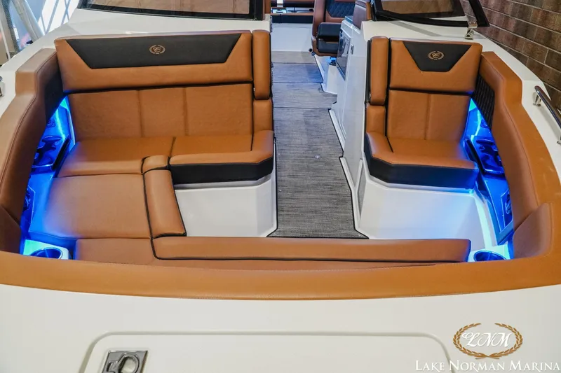 Slide: The Image of 2026 Cobalt R31 boat interior with brown leather seating and blue LED lighting. - 6