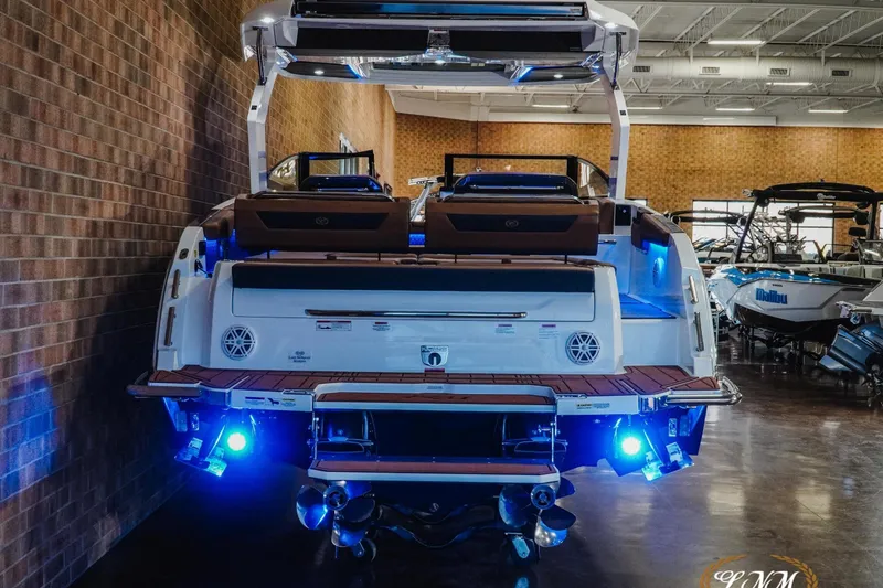 Slide: The Image of 2026 Cobalt R31 boat with illuminated blue lights in a showroom setting. - 8