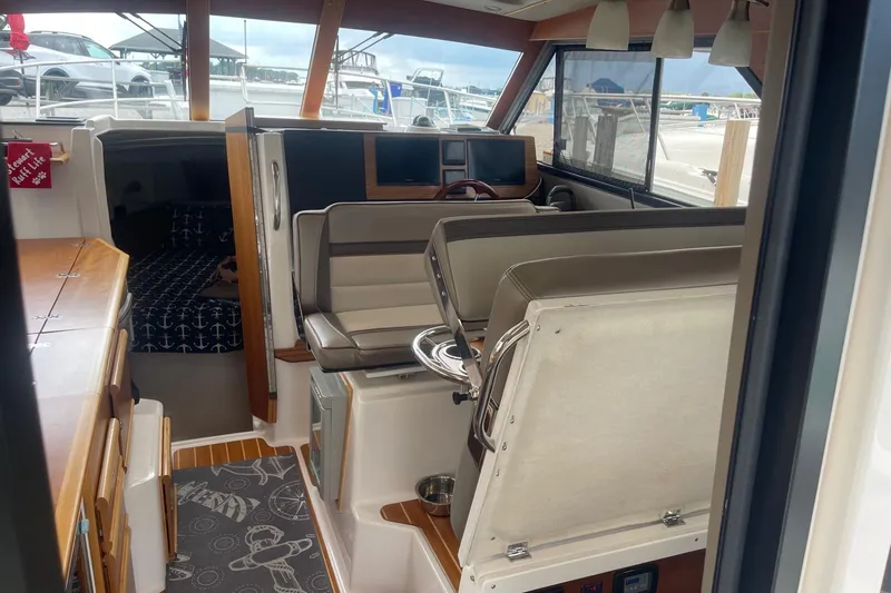 Slide: The Image of Interior of 2022 Cutwater C-30 Sedan boat with helm, seating, and cabin area. - 20