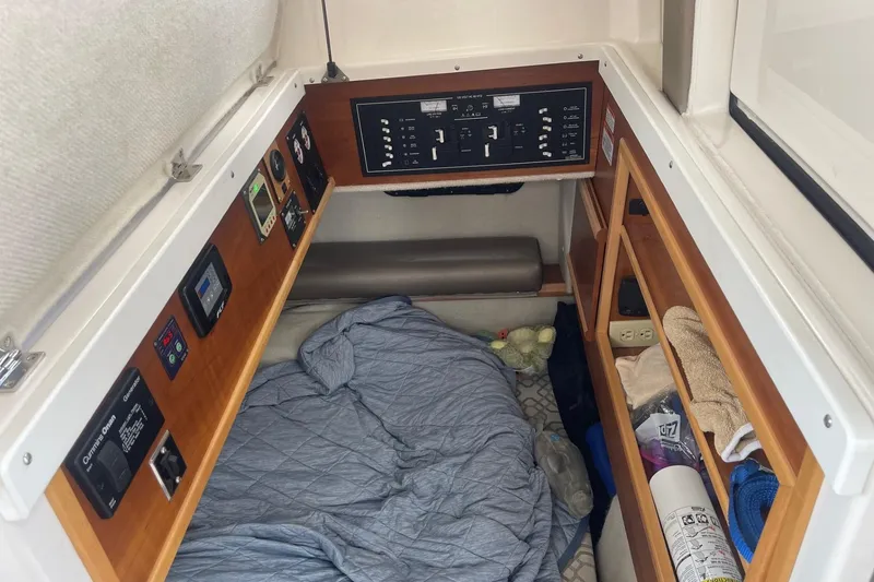 Slide: The Image of 2022 Cutwater C-30 Sedan cabin interior with control panels and sleeping area. - 24