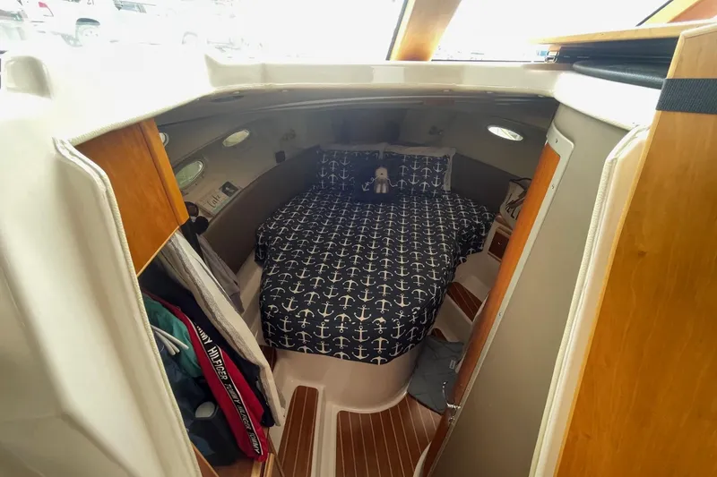 Slide: The Image of 2022 Cutwater C-30 Sedan cabin interior with anchor-themed bedding. - 38
