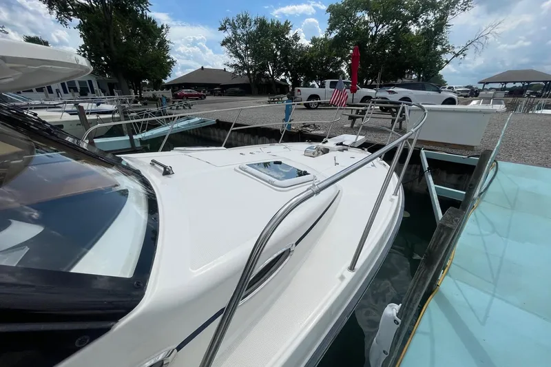 Slide: The Image of 2022 Cutwater C-30 Sedan docked, showcasing sleek design and spacious deck. - 4