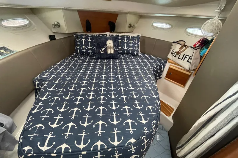 Slide: The Image of 2022 Cutwater C-30 Sedan cabin with anchor-themed bedding and cozy interior. - 40