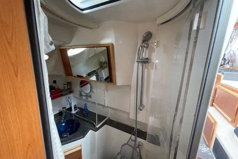 Slide: The Image of 2022 Cutwater C-30 Sedan bathroom with shower, sink, and mirror. - 46