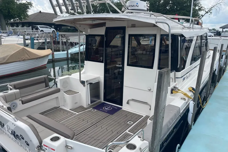 Slide: The Image of 2022 Cutwater C-30 Sedan docked, featuring spacious deck and modern design. - 8