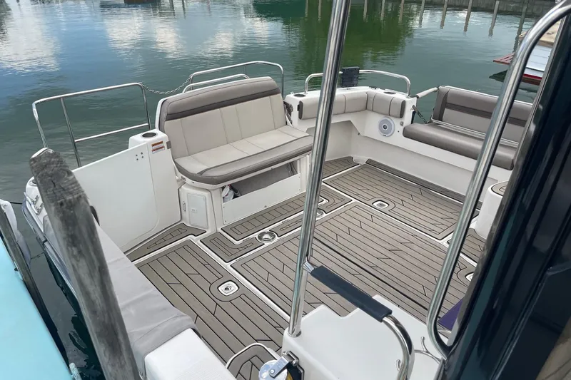 Slide: The Image of 2022 Cutwater C-30 Sedan boat interior with cushioned seating and wood-patterned flooring. - 9
