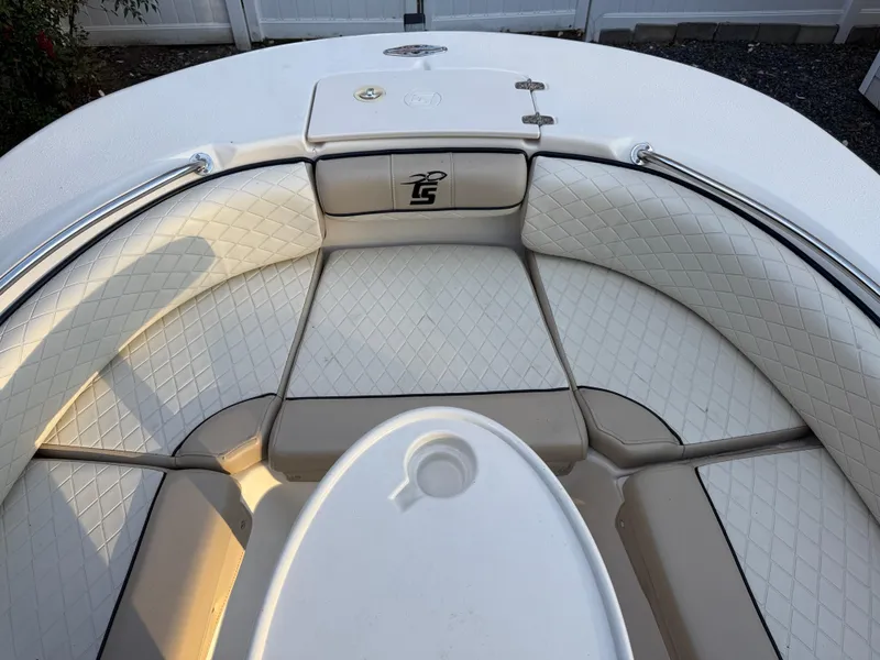 Slide: The Image of 2021 Carolina Skiff 23 Ultra Elite boat interior with cushioned seating and storage compartment. - 15