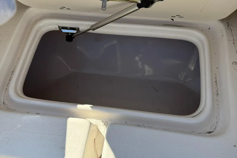 Slide: The Image of Open storage compartment on a 2021 Carolina Skiff 23 Ultra Elite boat. - 19