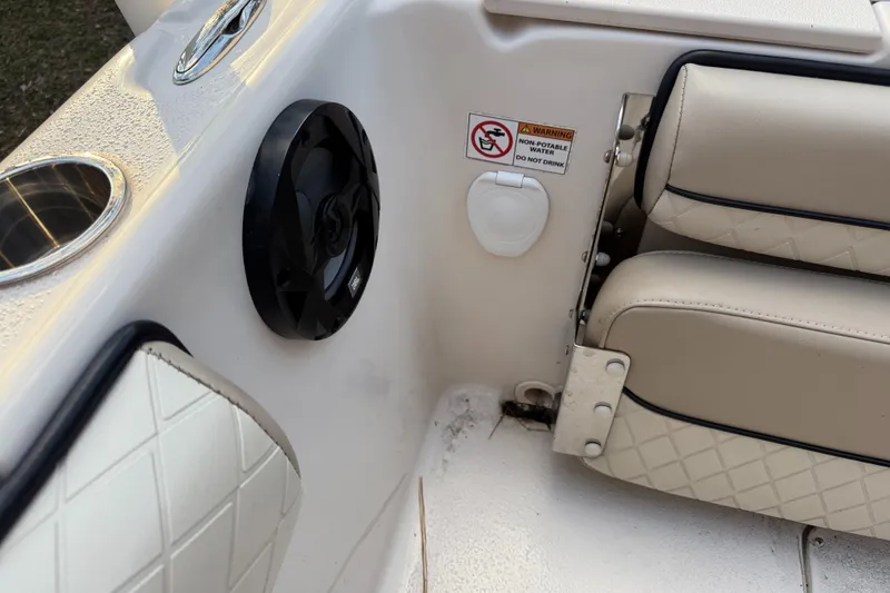 Slide: The Image of 2021 Carolina Skiff 23 Ultra Elite interior with speaker, cup holder, and cushioned seating. - 21