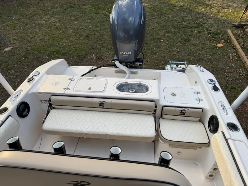 Slide: The Image of 2021 Carolina Skiff 23 Ultra Elite boat interior with seating and motor. - 6