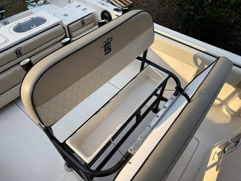 Slide: The Image of 2021 Carolina Skiff 23 Ultra Elite boat interior with cushioned seating and storage. - 9