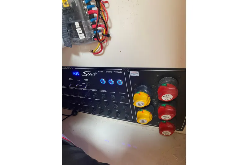Slide: The Image of Control panel of a 2019 Scout 255 Dorado boat with switches and wiring. - 10