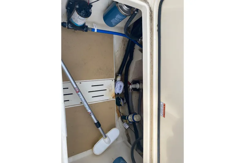 Slide: The Image of 2019 Scout 255 Dorado boat storage compartment with cleaning tools and equipment. - 17