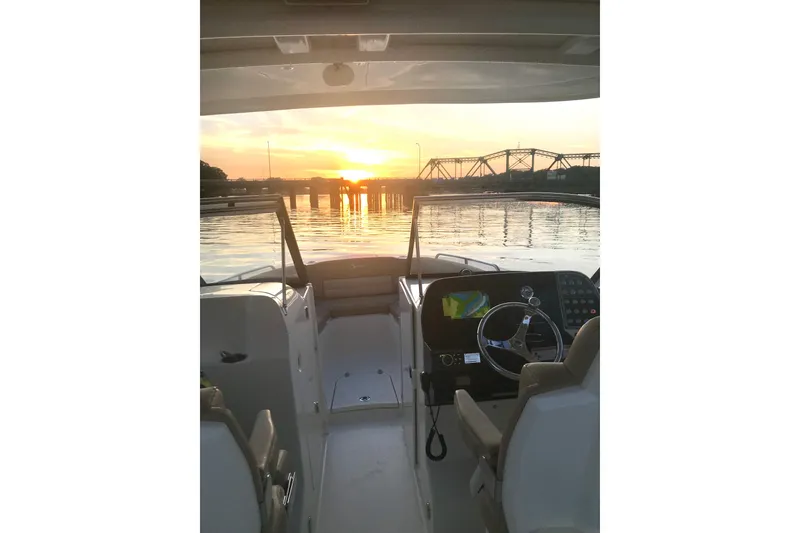 Slide: The Image of 2019 Scout 255 Dorado boat interior with sunset view over calm waters. - 18