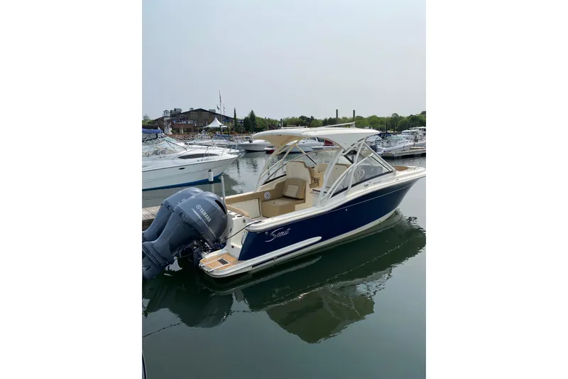 Slide: The Image of 2019 Scout 255 Dorado boat docked in marina, featuring Yamaha outboard motor. - 3