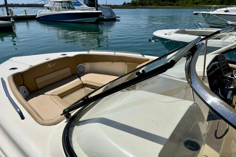 Slide: The Image of 2019 Scout 255 Dorado boat with tan seating, docked in a marina. - 5
