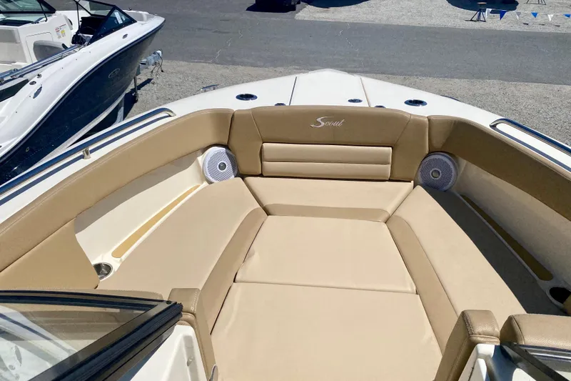 Slide: The Image of 2019 Scout 255 Dorado boat interior with beige seating and speakers. - 6