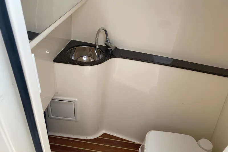Slide: The Image of 2019 Scout 255 Dorado boat interior with sink and toilet. - 9