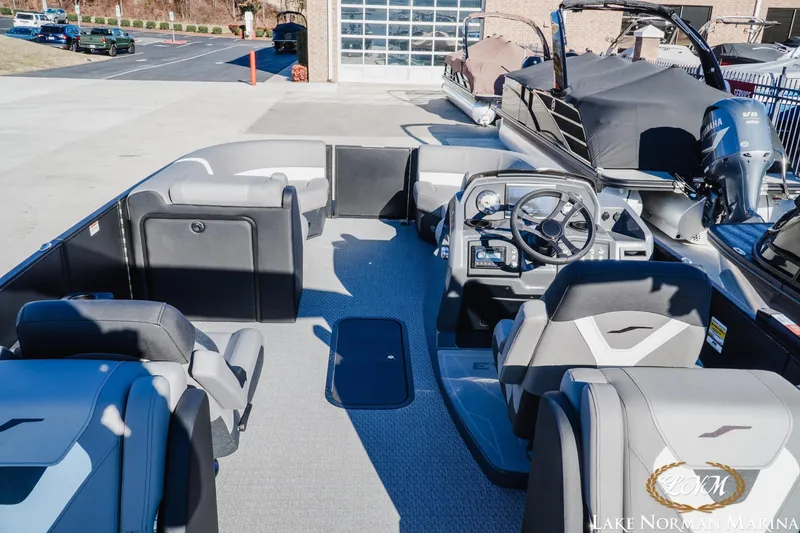 Slide: The Image of 2026 Evotti 523QL boat interior at Lake Norman Marina, featuring modern seating and controls. - 6