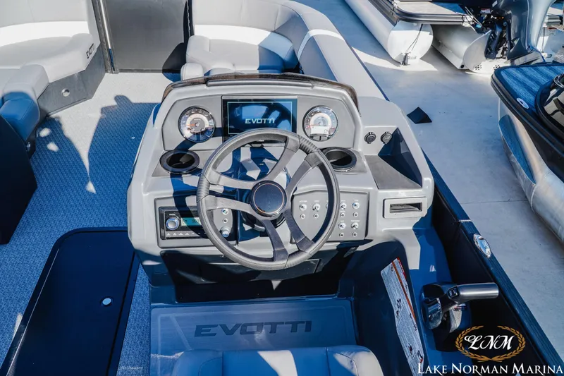 Slide: The Image of Cockpit of 2026 Evotti 523QL boat with steering wheel and control panel at Lake Norman Marina. - 9