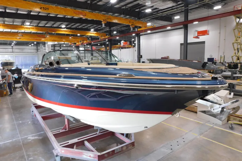 The Image of 2025 Chris-Craft Launch 27 boat in a manufacturing facility, showcasing sleek design and craftsmanship. - 0