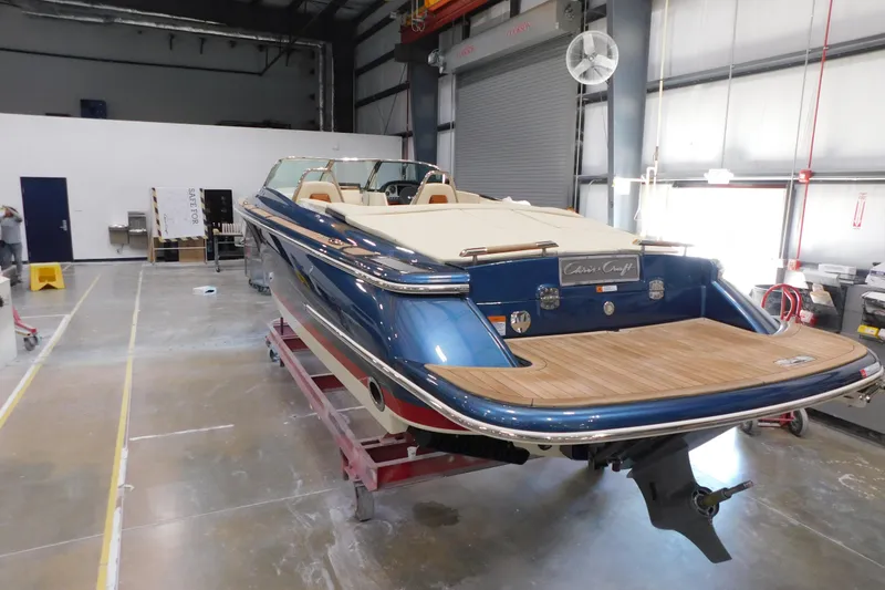 Slide: The Image of 2025 Chris-Craft Launch 27 boat in a workshop, showcasing sleek design and craftsmanship. - 10