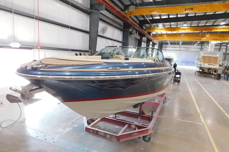 Slide: The Image of 2025 Chris-Craft Launch 27 boat in a manufacturing facility, showcasing sleek design and craftsmanship. - 12