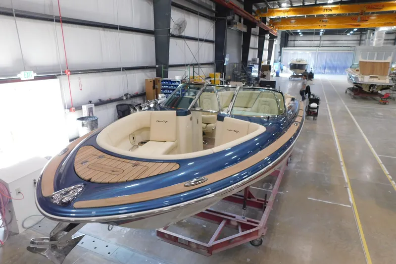 Slide: The Image of 2025 Chris-Craft Launch 27 boat in a manufacturing facility, showcasing elegant design and craftsmanship. - 13