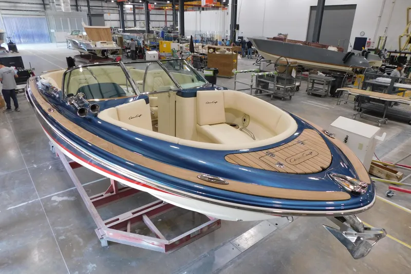 Slide: The Image of 2025 Chris-Craft Launch 27 boat in a workshop, showcasing elegant design and craftsmanship. - 15