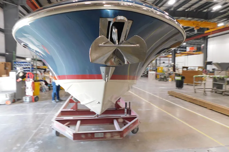 Slide: The Image of 2025 Chris-Craft Launch 27 boat in a manufacturing facility, showcasing its sleek design. - 2