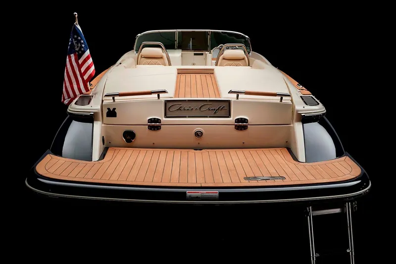 Slide: The Image of Manufacturer Provided Image: 2025 Chris-Craft Launch 27 boat with American flag, rear view, teak deck. - 26