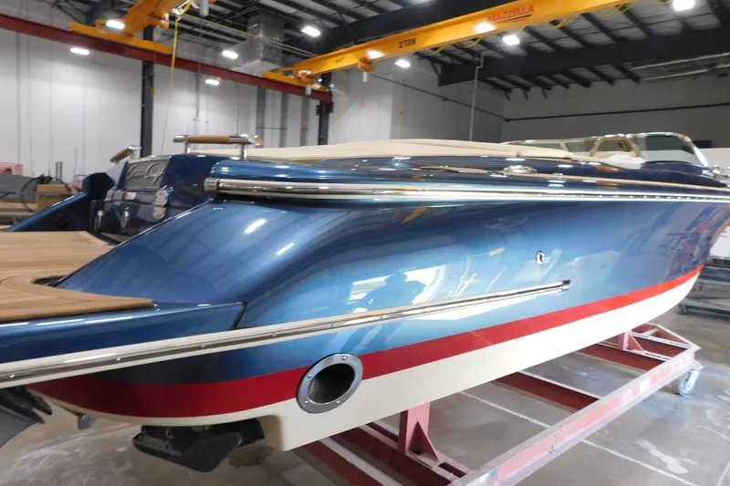 Slide: The Image of 2025 Chris-Craft Launch 27 boat in a showroom, featuring sleek blue and red design. - 4