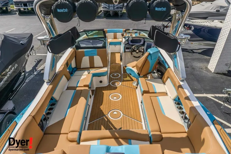 Slide: The Image of 2022 MasterCraft X24 boat interior with luxurious seating and modern dashboard. - 12