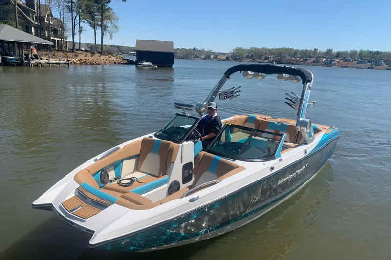 Slide: The Image of 2022 MasterCraft X24 boat on a lake with a person at the helm. - 5