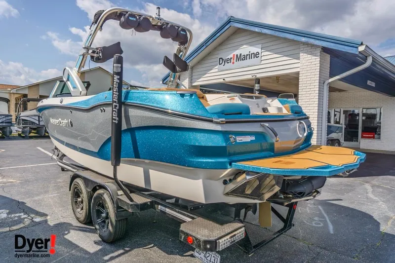 Slide: The Image of 2022 MasterCraft X24 boat in blue at Dyer Marine dealership. - 6