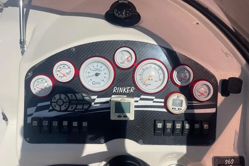 Slide: The Image of Dashboard of a 2001 Rinker 262 Captiva boat with gauges and controls. - 10