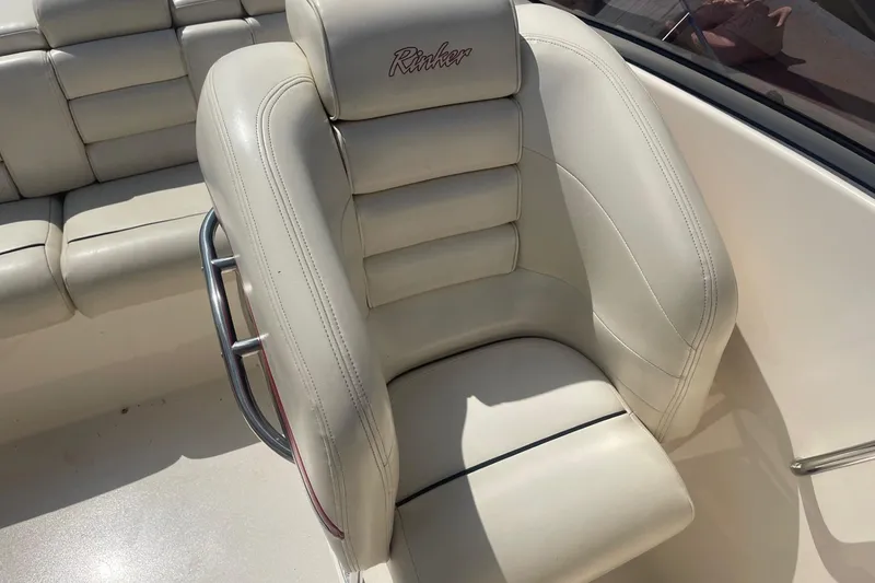 Slide: The Image of Cream leather seat on 2001 Rinker 262 Captiva boat, featuring stitched detailing and chrome handle. - 13